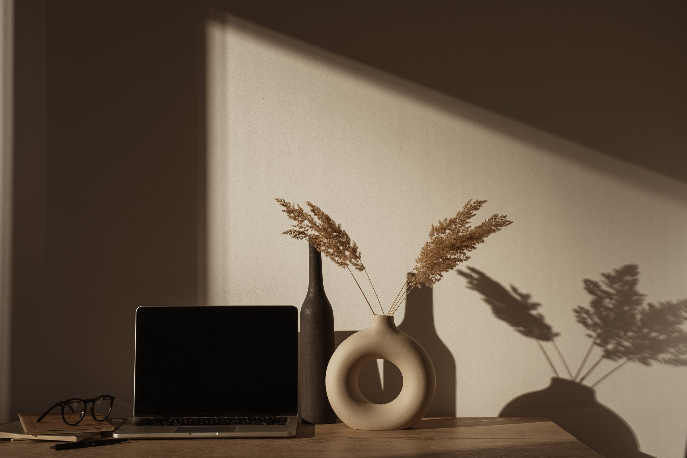 Laptop Computer with Pampas Grass in Vase on Desk